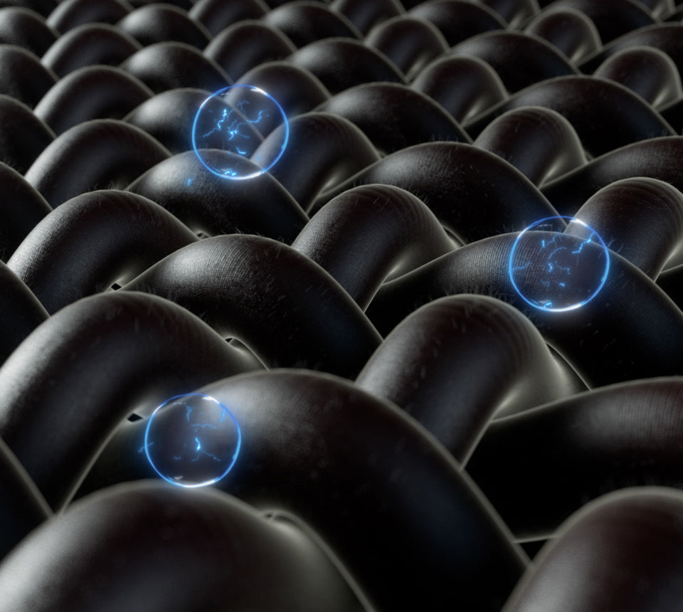 Close-up of dark textured surface with glowing blue circles