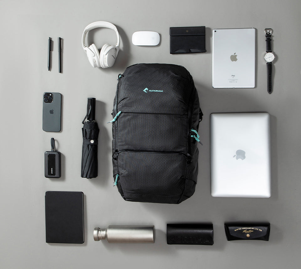 Flat lay of everyday carry backpack with tech essentials showcasing smart organization