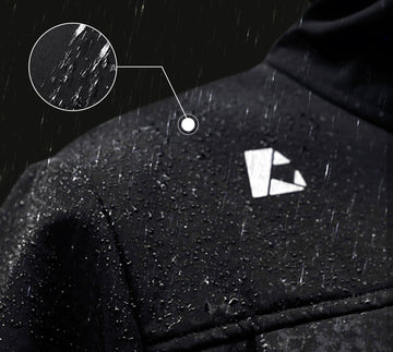 Close-up of a raincoat with water droplets and a brand logo on a dark background